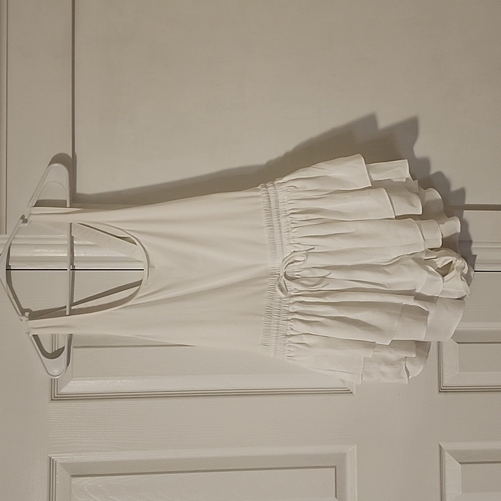 White one-piece, ruffled short bottom